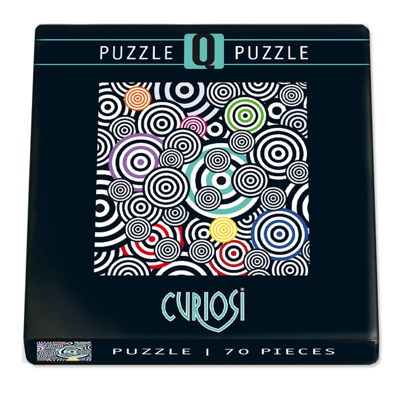 CURIOSI | Frontansicht der Produktverpackung des Puzzle Q "POP 1" mit schwarz-weißem Motiv, bunten Akzenten und überlagerten Kreisformen