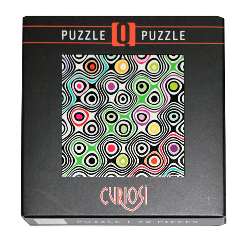 CURIOSI | Produktverpackung des Puzzle Q "Shake 1" mit abstraktem, schwarz weißen Motiv und bunten Akzenten